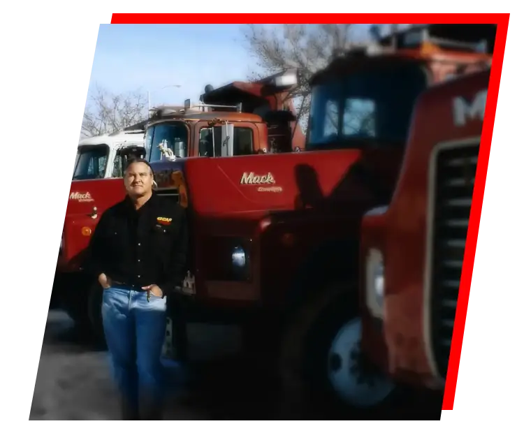 a person standing in front of a row of red trucks